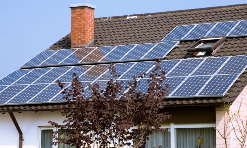 Photo of solar panels on a tiled, slanted roof of house
