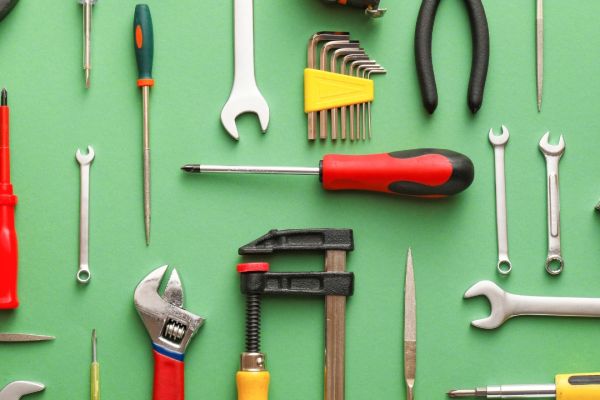 Image of various tools on a green background