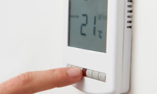 Finger pushing button to turn down temperature